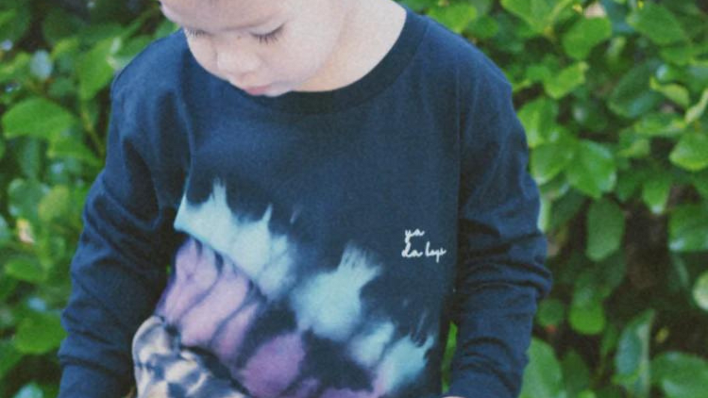 Boy with tie dye top on with decal