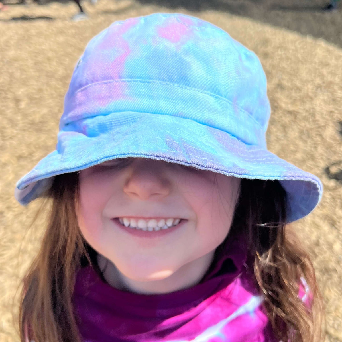 Child wearing a colorful bucket hat outdoors